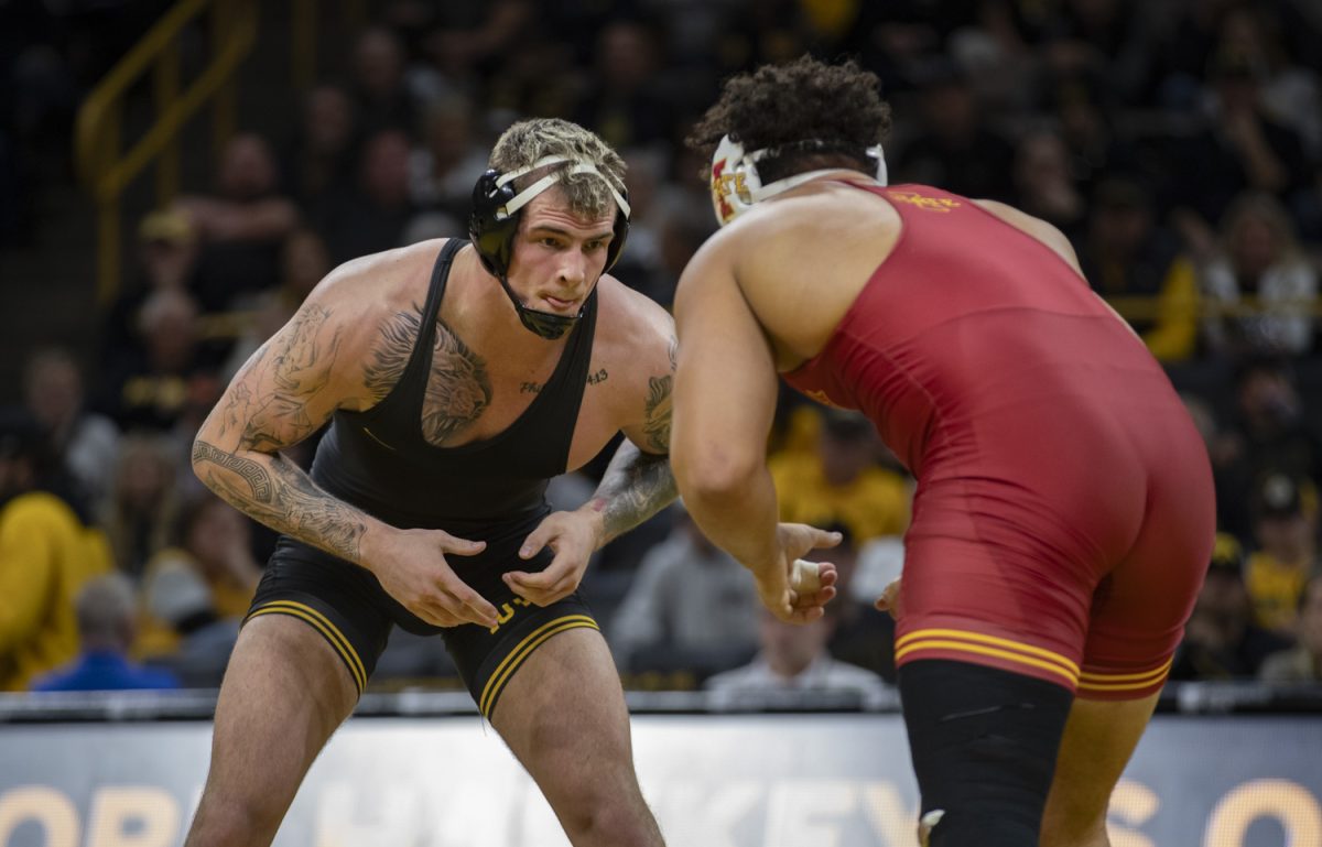 Iowa’s No. 13 285-pound Ben Kueter faces off against Iowa State’s No. 4 Longer Bastida during a Cy-Hawk men’s wrestling dual between No. 2 Iowa and No. 12 Iowa State at Carver-Hawkeye Arena in Iowa City on Saturday, Nov. 23, 2024. The Hawkeyes defeated the Cyclones 21-15.