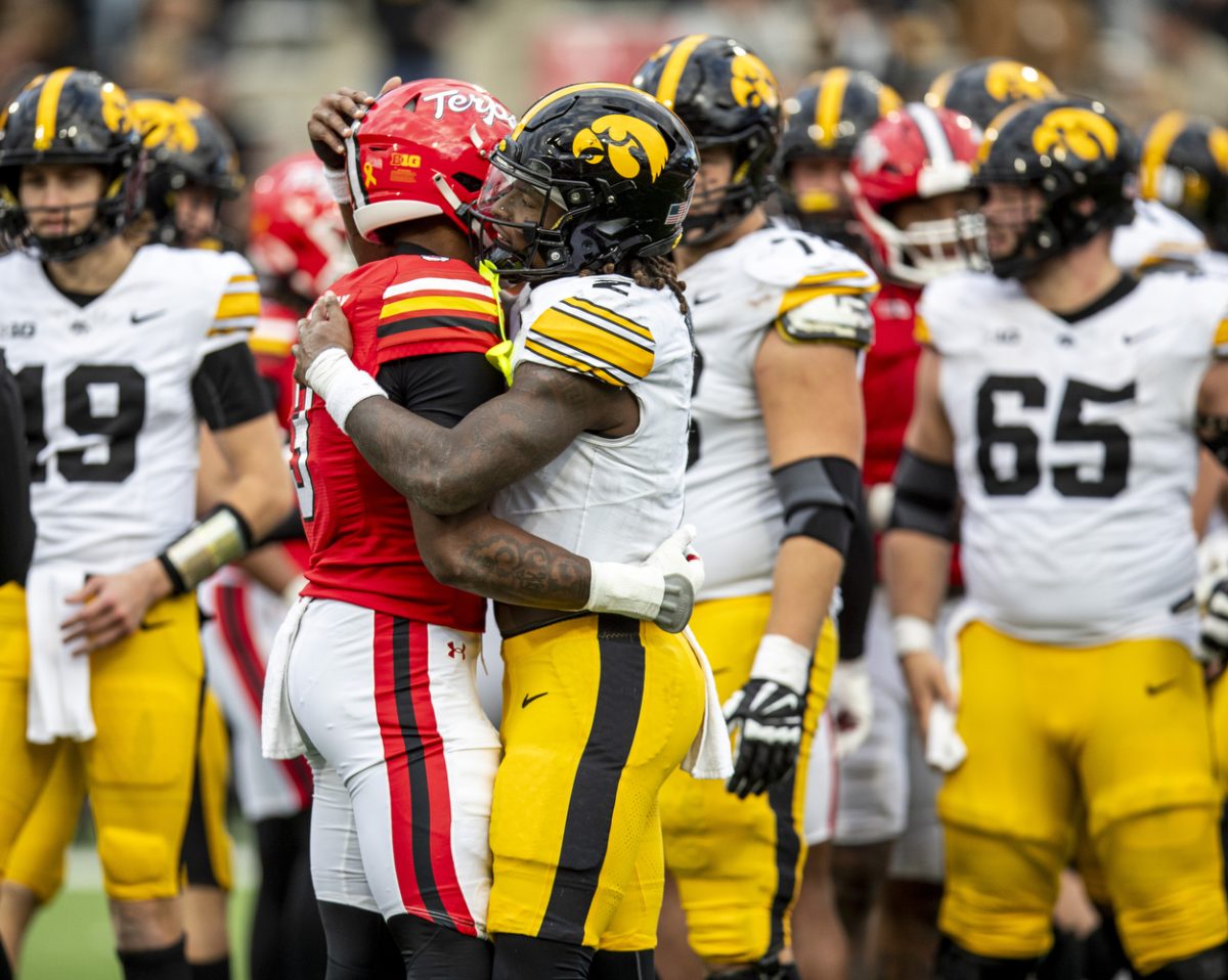 Iowa running back Kaleb Johnson embraces Maryland linebacker Trey Reddick following a football game between Iowa and Maryland at SECU Stadium in College Park, Md. on Saturday, Nov. 23, 2024. Johnson had 35 carries, 164 yards, and one touchdown. The Hawkeyes defeated the Terrapins 29-13.