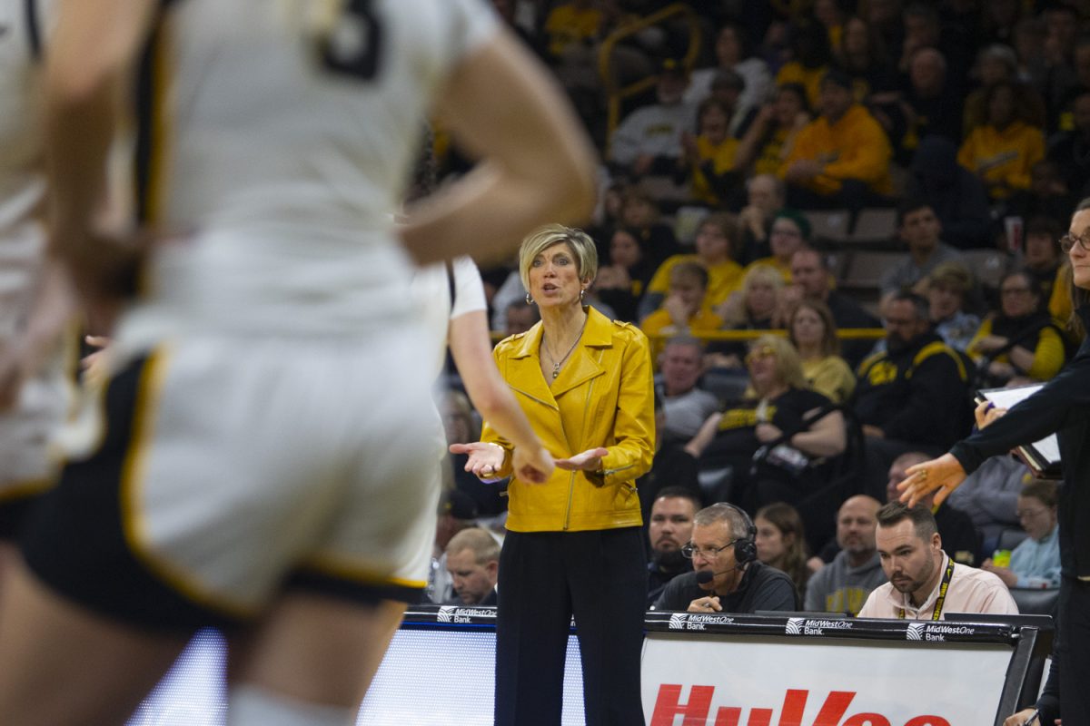 Iowa head coach Jan Jensen talks to a player during a women's basketball game between Iowa and Washington State at Carver-Hawkeye Arena in Iowa City, on Sunday, Nov. 24, 2024. The Hawkeyes defeated the Cougars 72-43.