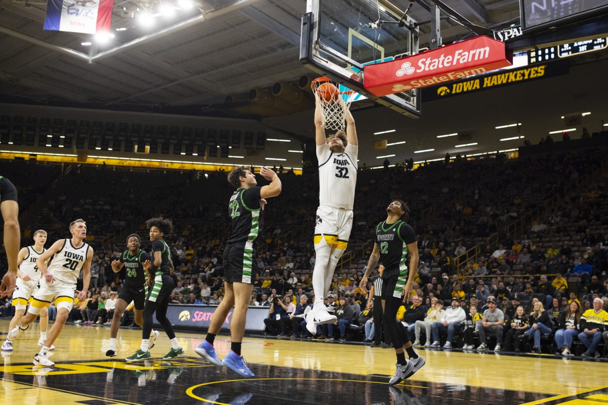 Owen Freeman dunks the ball during a mens basketball game between Iowa and USC Upstate at Carver-Hawkeye Arena in Iowa City, on Tuesday, Nov. 26, 2024. The Hawkeyes defeated the Spartans 110-77.