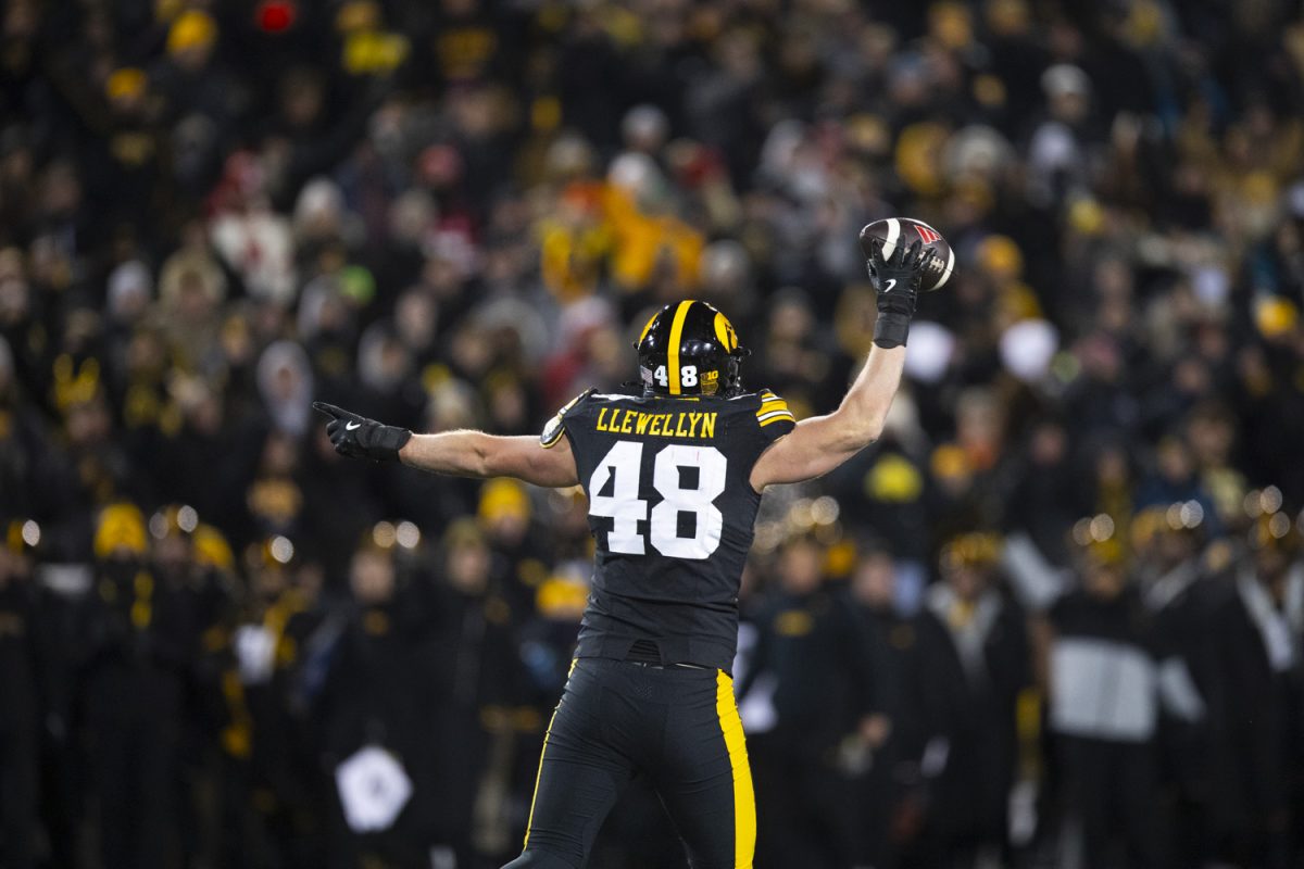 Iowa defensive lineman Max Llewellyn signals possession of the ball during a football game between Iowa and Nebraska at Kinnick Stadium in Iowa City on Friday, Nov. 29, 2024. Iowa defeated Nebraska, 13-10.