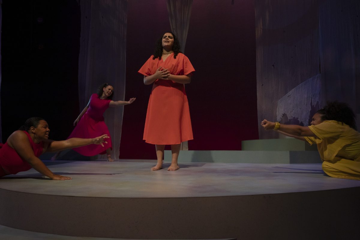 Niyati Deshpande (center) speaks from the middle of the stage while other cast members dance around her. For colored girls who have considered suicide / when the rainbow is enuf by Ntozake Shange is running at the E.C Mabie Theater in the UI Theatre building from Nov. 8 to Nov. 16.