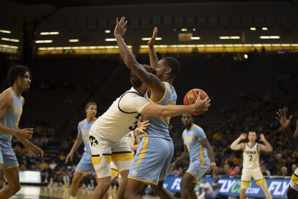 Owen Freeman attempts a pass around Dionjahe Thomas during the Iowa Men’s basketball game against Southern University on Nov. 7 at Carver Hawkeye Arena in Iowa City, Iowa. The Hawkeye men battled and won 89-74 over the Jaguars.