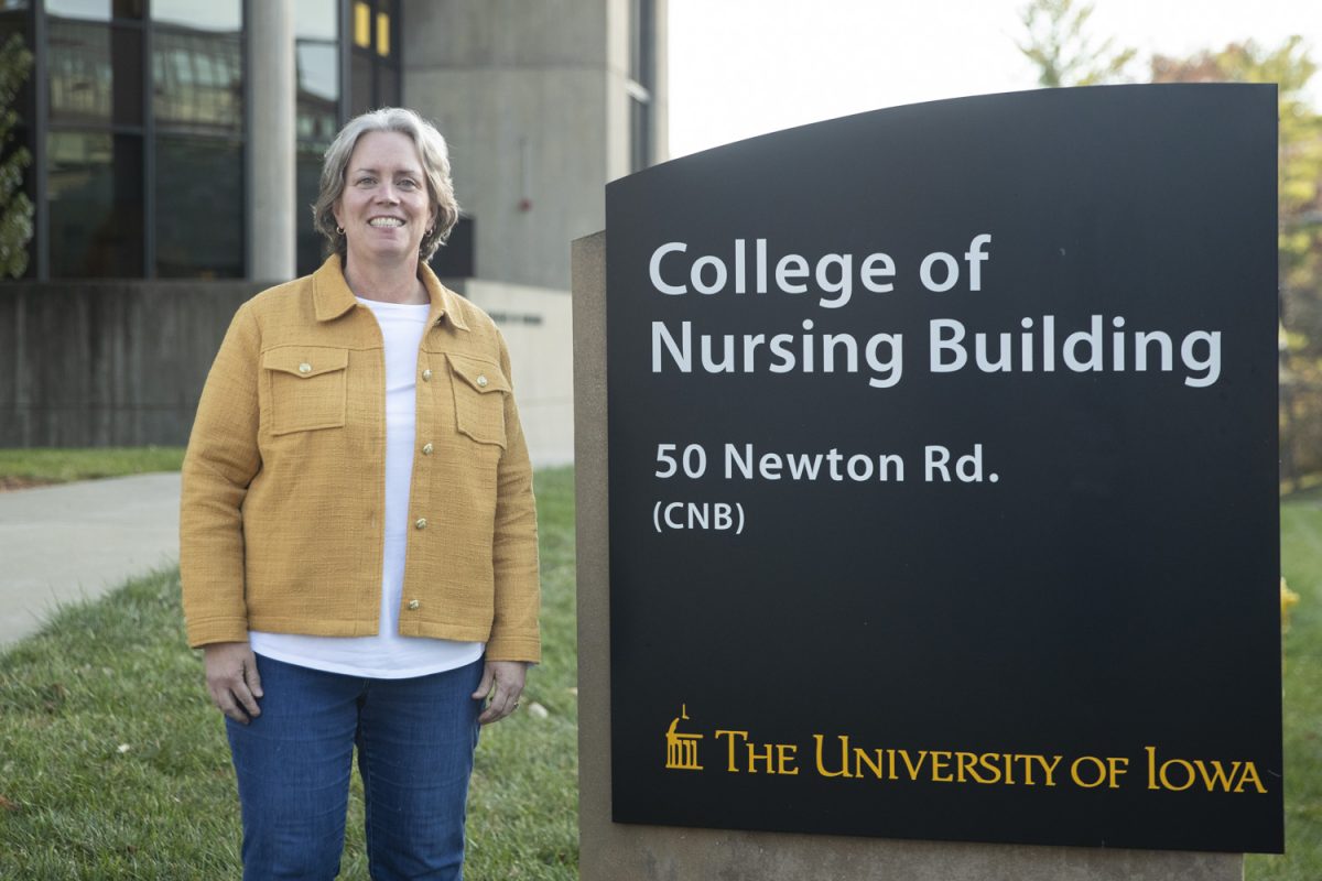 Tess Judge-Ellis, clinical associate professor and nurse practitioner, poses for a portrait in front of the College of Nursing Building on Nov. 8, 2024. Judge-Ellis is a former army nurse, and now focuses her work in mental health and holistic approaches to healthcare.