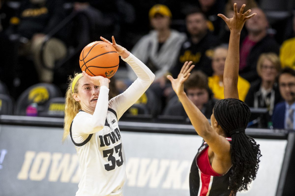 Iowa guard Lucy Olsen goes up for a 3-point shot during a women’s basketball game between Iowa and Northern Illinois at Carver-Hawkeye Arena in Iowa City on Wednesday, Nov. 6, 2024. Following the half the Hawkeyes lead the Huskies 45-34.