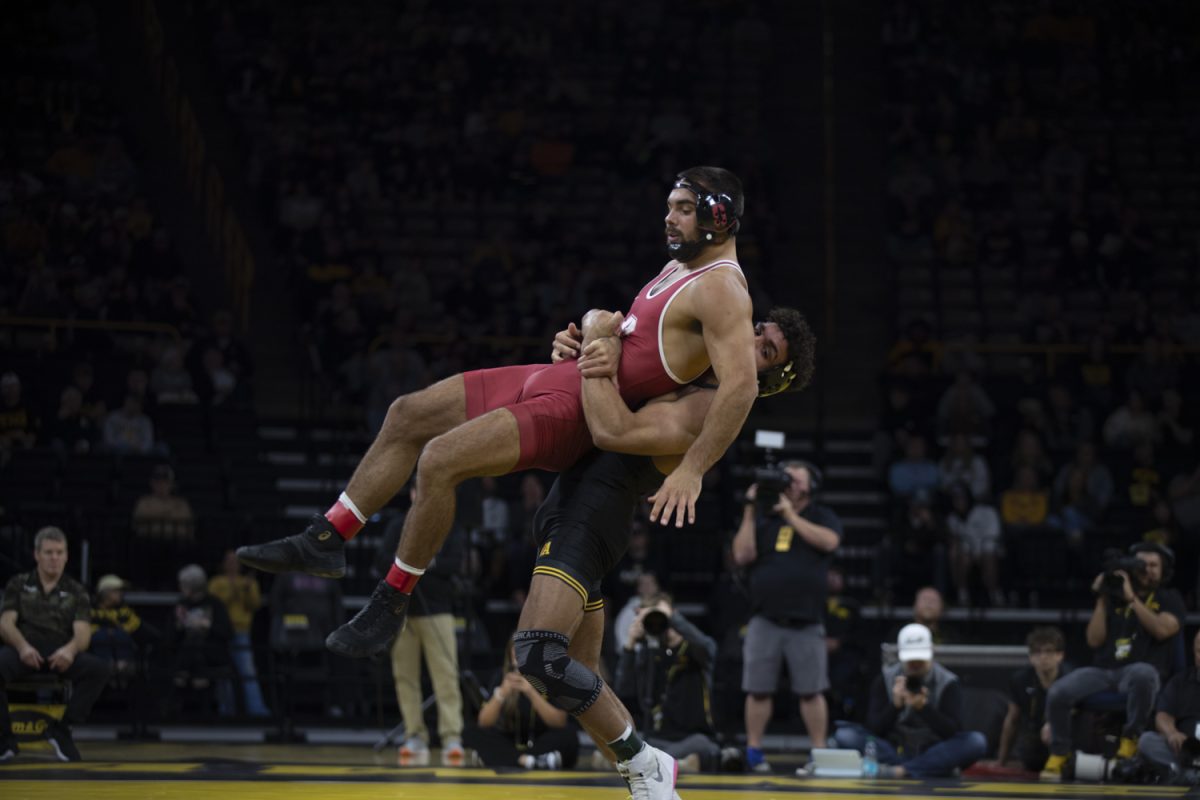 Iowa No. 2 197-pound Stephen Buchanan flips Stanford No. 17 197-pound Nick Stemmet while wrestling during No. 2 Iowa’s first home dual against No. 20 Stanford at Carver-Hawkeye Arena in Iowa City on Saturday, Nov. 9, 2024. The Hawkeyes defeated the Tree, 32-9. Buchanan defeated Stemmet, 18-1.