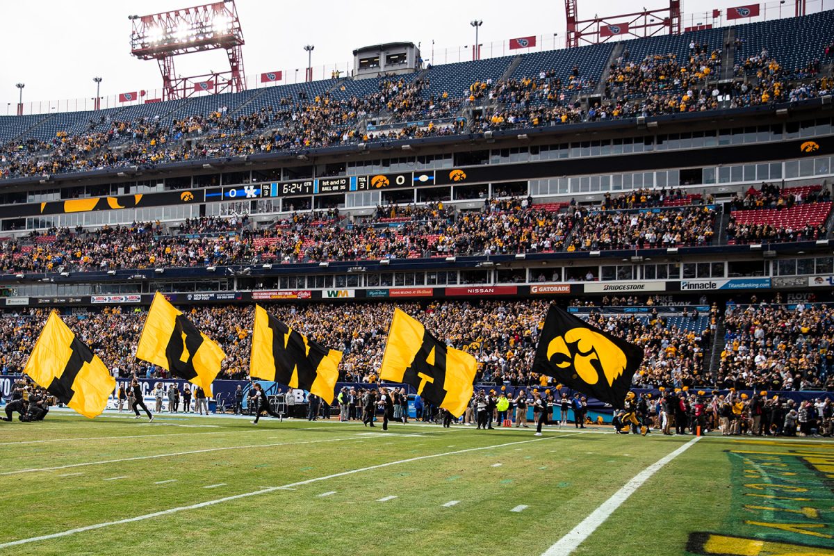 The Iowa spirit squad trots out flags during the 2022 TransPerfect Music City Bowl between Iowa and Kentucky at Nissan Stadium in Nashville. The Hawkeyes defeated the Wildcats, 21-0. (Jerod Ringwald/The Daily Iowan) 