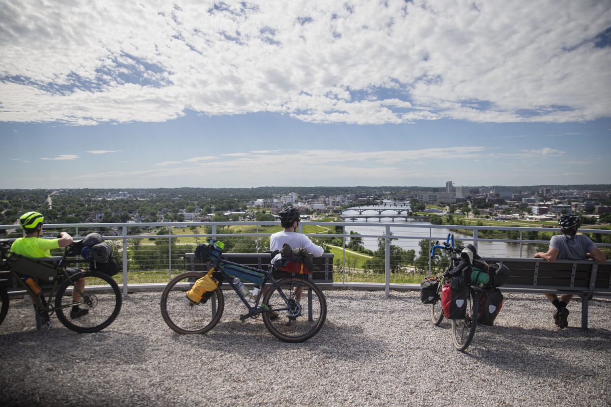 David Butler, Elijah Mickey and Jason McCartney look at the skyline of Cedar Rapids, Iowa from the top of Mt. Trashmore on Wednesday, June 5, 2024. 