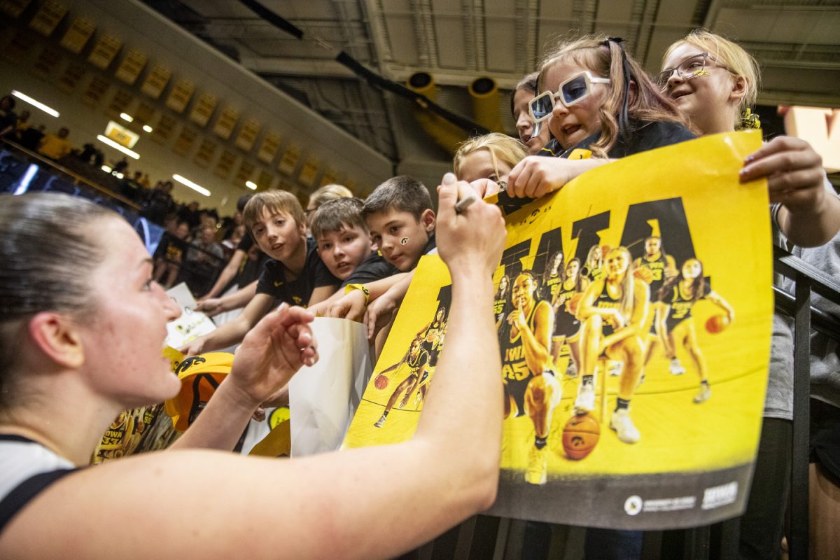 Iowa guard Taylor Stremlow signs fans merchandise following a women’s basketball game between Iowa and Missouri Western State at Carver-Hawkeye Arena in Iowa City on Wednesday, Oct. 30, 2024. The Hawkeyes defeated the Griffons 110-55. 