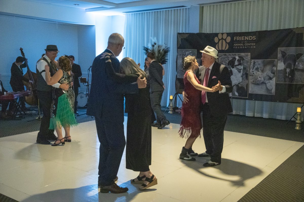 Attendees dance to a jazz band during the Roaring ‘20s Gala benefit for the Friends of the Animal Center Foundation in Iowa City on Nov. 16. Bread Garden Events hosted the meal and charity auction to help shelter dogs and cats in Johnson County.