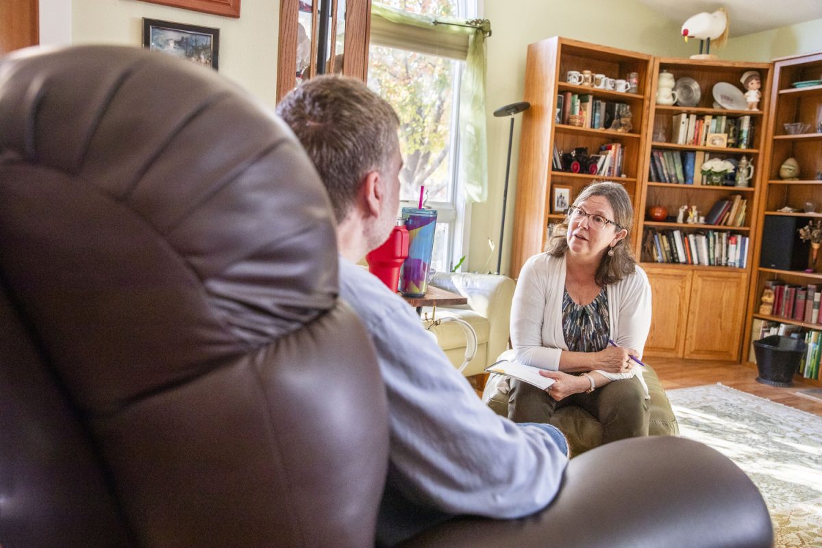 Mark Kay Kusner, a death doula in Iowa City, meets with Mike Bosch in his and his wife Joni’s home in Iowa City Iowa on Thursday, Oct. 24, 2024. Bosch was diagnosed with Multiple System Atrophy in 2023, and has seen a significant decline in his quality of life. In his work with Kusner, Bosch is talking through fears, writing letters to loved ones and documenting his life experiences. Bosch said he has felt comfortable with the venerability Kusner has encouraged. “She's really kind; you're not embarrassed if you cry in front of her,” he said.