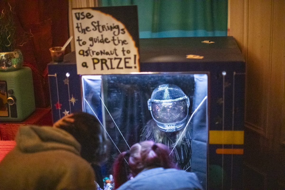 A volunteer works behind the scenes of a game during the Dada Prom, held at Public Space One on Saturday, Dec. 7, 2024. The event, celebrating the absurdist art form, had an immersive exhibit throughout the venue and a costume contest for attendees who dressed up.