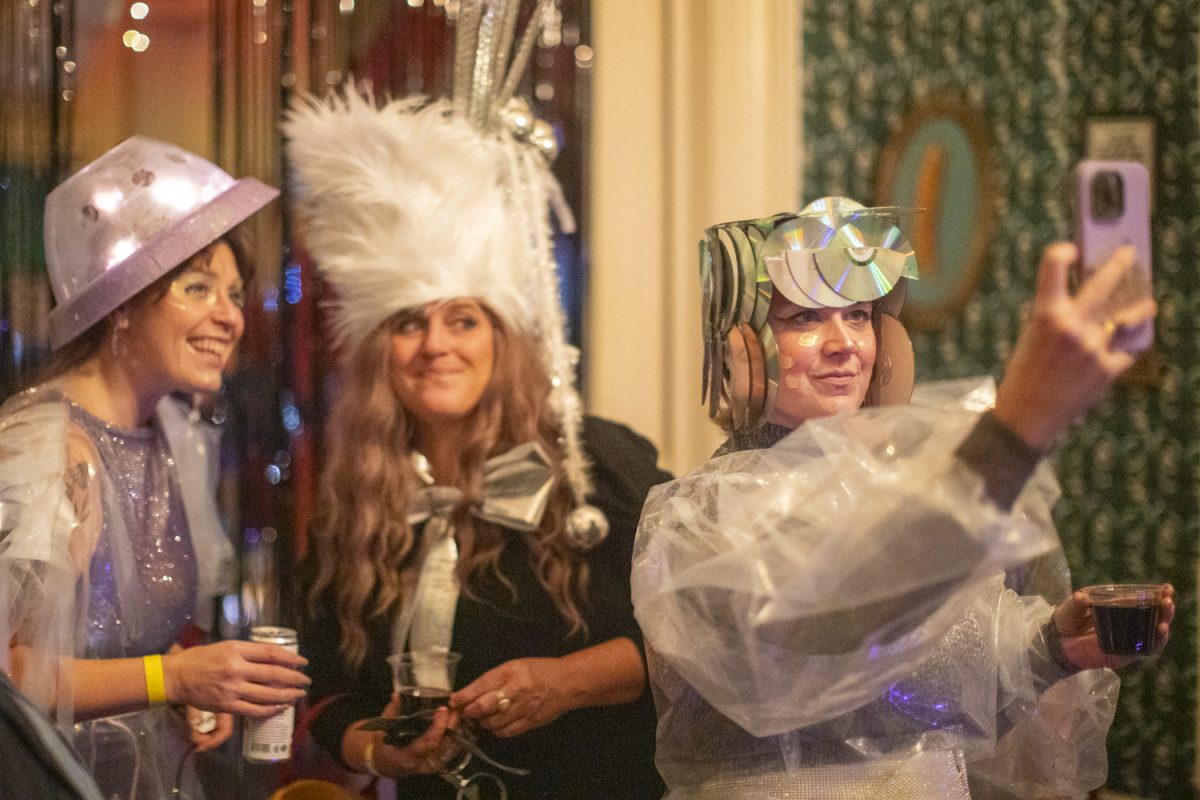 Attendees take a selfie during the Dada Prom Fundraiser held at Public Space One on Dec. 7. The event celebrated the absurdist art form with an immersive exhibit throughout the venue and a costume contest for attendees who dressed up.