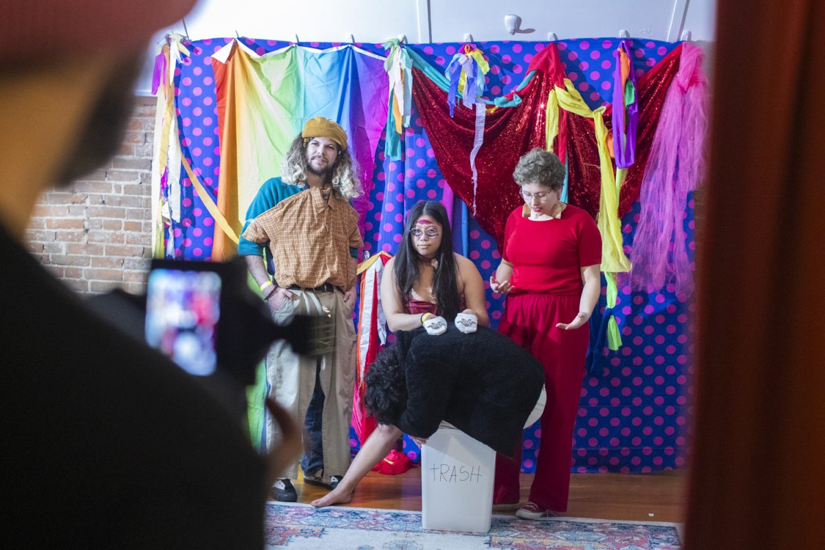 Attendees take a photo during the Dada Prom, held at Public Space One on Saturday, Dec. 7, 2024. The event, celebrating the absurdist art form, had an immersive exhibit throughout the venue and a costume contest for attendees who dressed up.