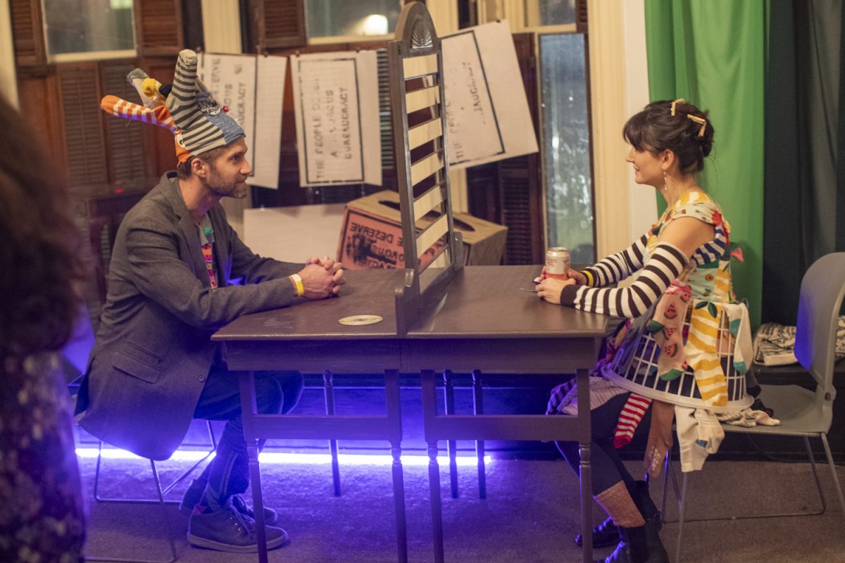 Attendees play with an optical illusion game during the Dada Prom, held at Public Space One on Saturday, Dec. 7, 2024. The event, celebrating the absurdist art form, had an immersive exhibit throughout the venue and a costume contest for attendees who dressed up.