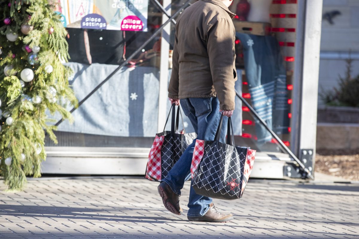 A shopper pass through the Pedestrian Mall on Tuesday, Dec. 10, 2024. Since the holiday pop-up shops were installed in November and December, there has been an increase in shopping downtown.