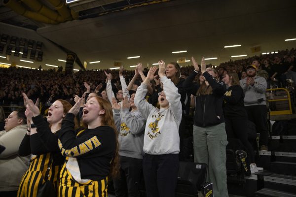 Iowa fans applaud during the Iowa Corn Cy-Hawk Series, a basketball game between Iowa and Iowa State at Carver-Hawkeye Arena in Iowa City, Iowa on Wednesday, Dec. 11, 2024. The Hawkeyes defeated the Cyclones 75-69.