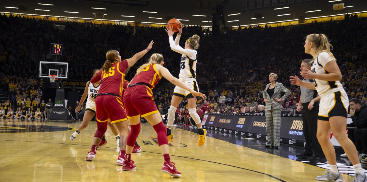 Lucy Olsen passes the ball during the Iowa Corn Cy-Hawk Series, a basketball game between Iowa and Iowa State at Carver-Hawkeye Arena in Iowa City on Wednesday, Dec. 11, 2024. The Hawkeyes defeated the Cyclones 75-69.