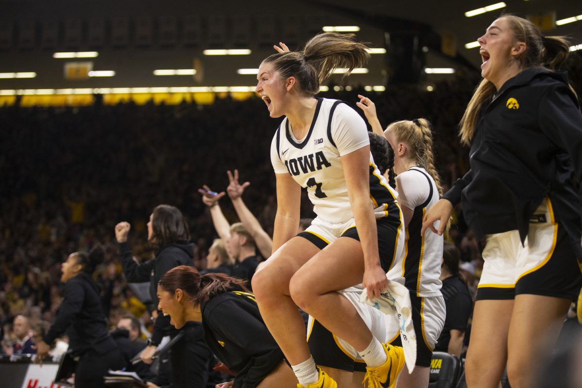 Taylor Stremlow reacts to a three-pointer during the Iowa Corn Cy-Hawk Series, a basketball game between Iowa and Iowa State at Carver-Hawkeye Arena in Iowa City on Wednesday, Dec. 11, 2024. The Hawkeyes defeated the Cyclones 75-69.