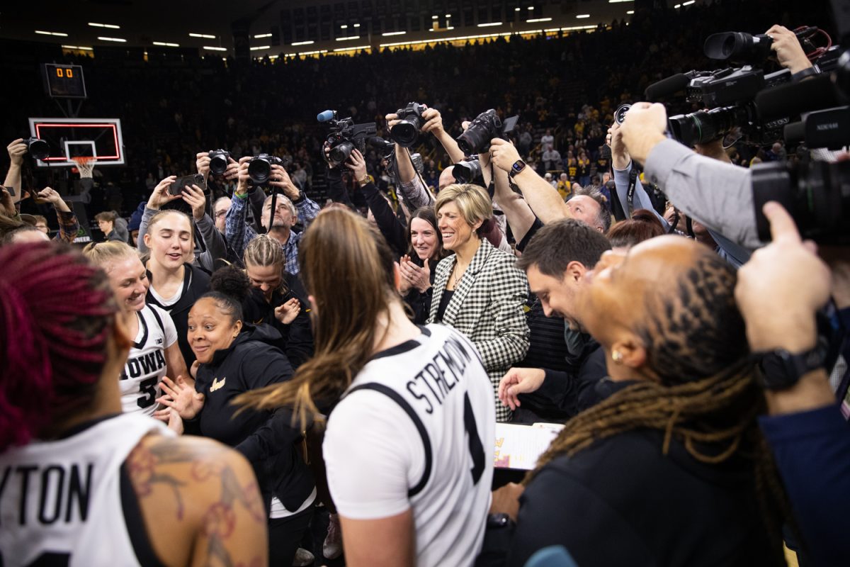 Jan Jensen celebrates a victory against Iowa State after the Iowa Corn Cy-Hawk Series at Carver-Hawkeye Arena in Iowa City on Wednesday, Dec. 11, 2024. The Hawkeyes defeated the Cyclones 87-75.