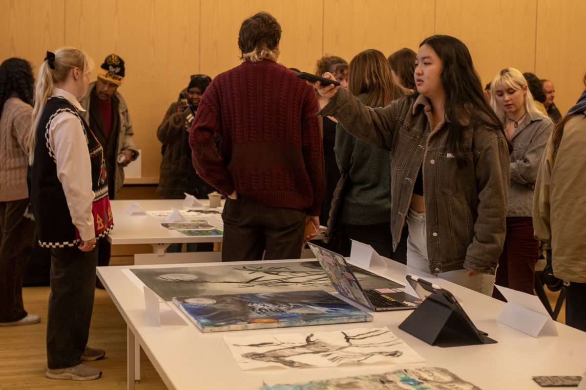 Attendees look at student work during an exhibit of ink art at the Stanley Museum of Art on Thursday, Dec. 12, 2024. Students in Brushwork in Chinese Art, a class taught by Assistant Professor Amy Huang, led presentations and showcased their work from the semester.