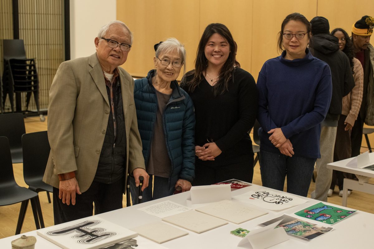 Assistant Professor Amy Huang (center) stands with Professor Emeritus Ramon Lin and his family during an exhibit of ink art at the Stanley Museum of Art on Thursday, Dec. 12, 2024. Students in Brushwork in Chinese Art, a class taught by Prof. Huang, led presentations and showcased their work from the semester.