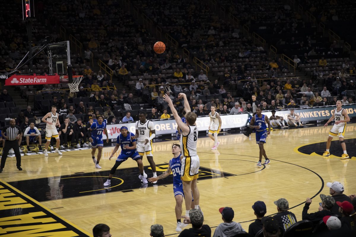 Cooper Koch shoots a three-pointer during the Holiday Hoopla matchup between the Iowa Hawkeyes and the New Orleans Privateers at Carver-Hawkeye Arena on Sunday, Dec. 15 in Iowa City, Iowa. The Hawkeyes claimed victory, 104-57.