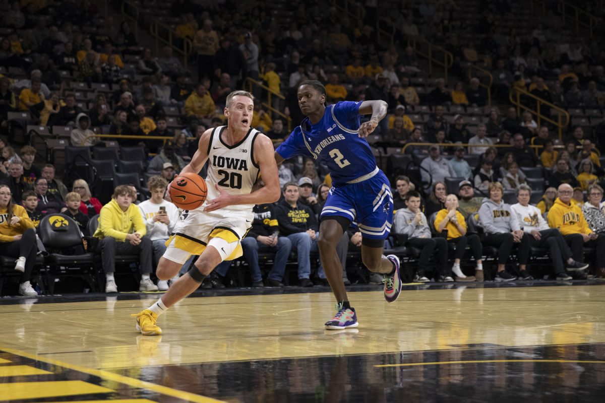 Payton Sandfort looks to dribble past Jah Short during the Holiday Hoopla matchup between the Iowa Hawkeyes and the New Orleans Privateers at Carver-Hawkeye Arena on Sunday, Dec. 15 in Iowa City, Iowa. The Hawkeyes claimed victory, 104-57.