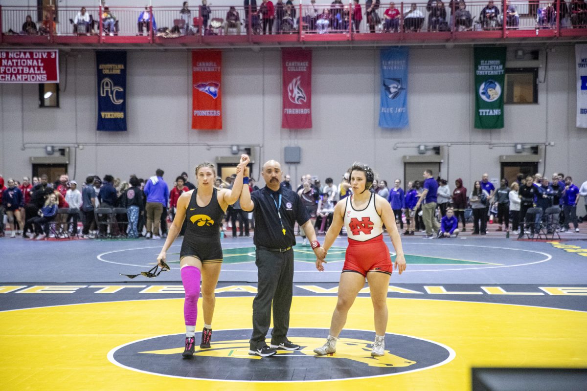 An official signals Iowa 180-pound Kylie Welker’s victory over North Central’s Tatum Heikkila during the 2024 NCC Open Tournament at the North Central College Recreation Center in Naperville, Ill, on Sunday, Dec. 15, 2024. Iowa finished second place just behind North Central with a team score of 148.5 points. Welker placed first place in the tournament