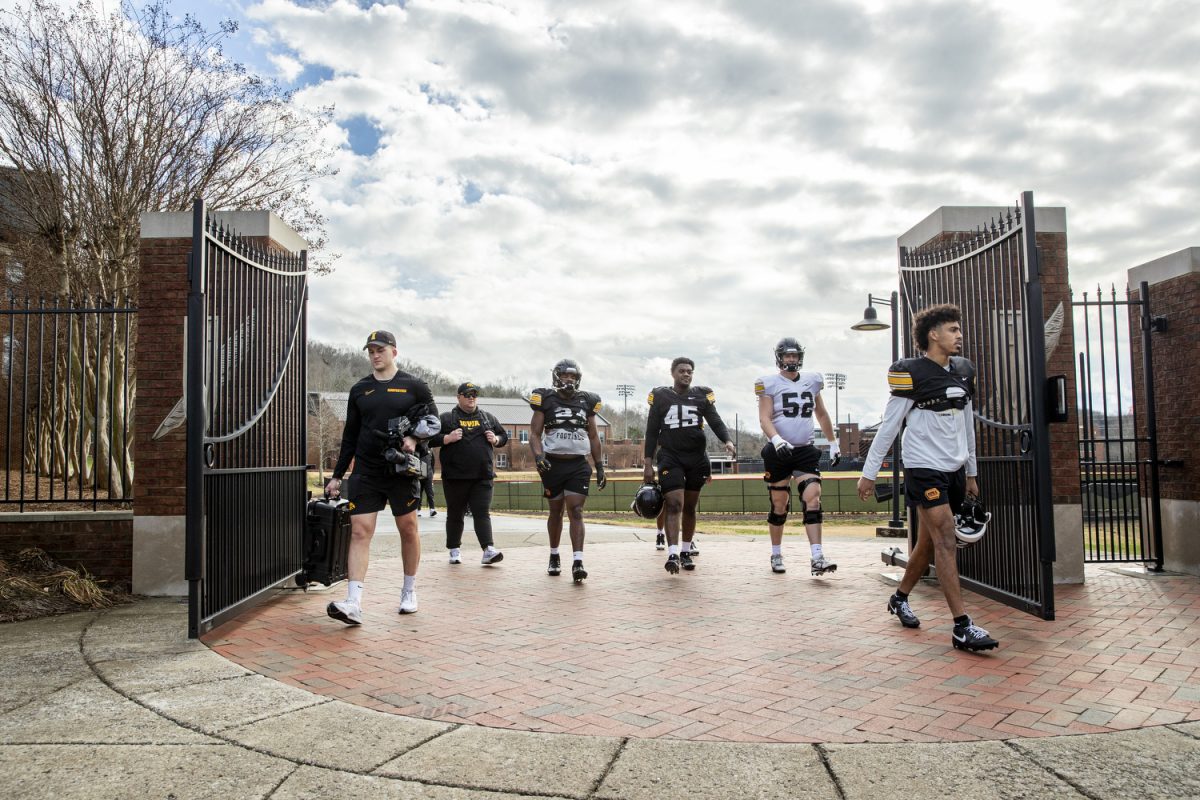 Players and staff make their way to the Ensworths Turf Field and Track during an Iowa football practice at Ensworth High School in Nashville, Tenn., on Friday, Dec. 27, 2024. The Iowa Hawkeyes and Missouri Tigers will face off in the 2024 TransPerfect Music City Bowl on Monday, Dec. 30, at Nissan Stadium.