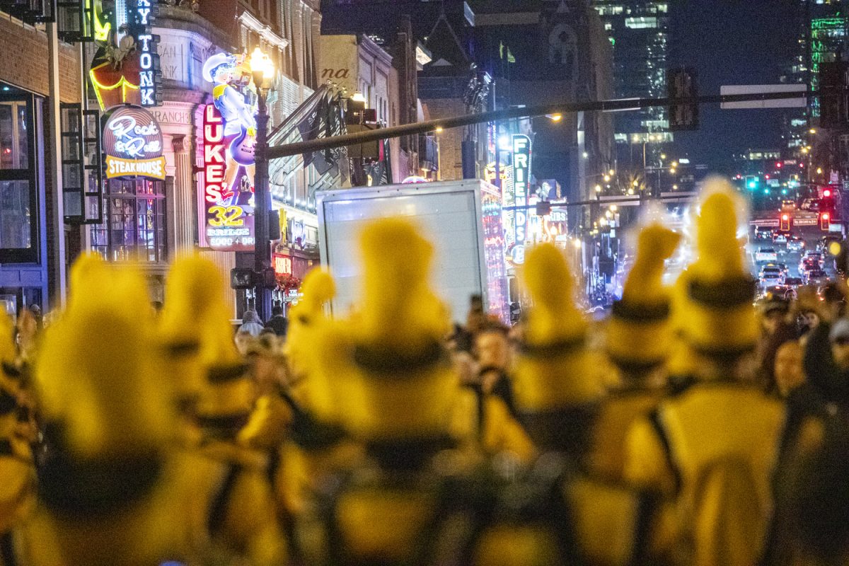 Iowa band members march during the TransPerfect Music City Bowl Battle of the Bands between the Hawkeye Marching Band and Marching Mizzou on Broadway Street in Nashville, Tenn., on Sunday, Dec. 29, 2024. The opposing team’s bands flooded the streets to play fight songs and other tunes. The Iowa Hawkeyes and Missouri Tigers will face off in the 2024 TransPerfect Music City Bowl on Monday, Dec. 30, at Nissan Stadium.