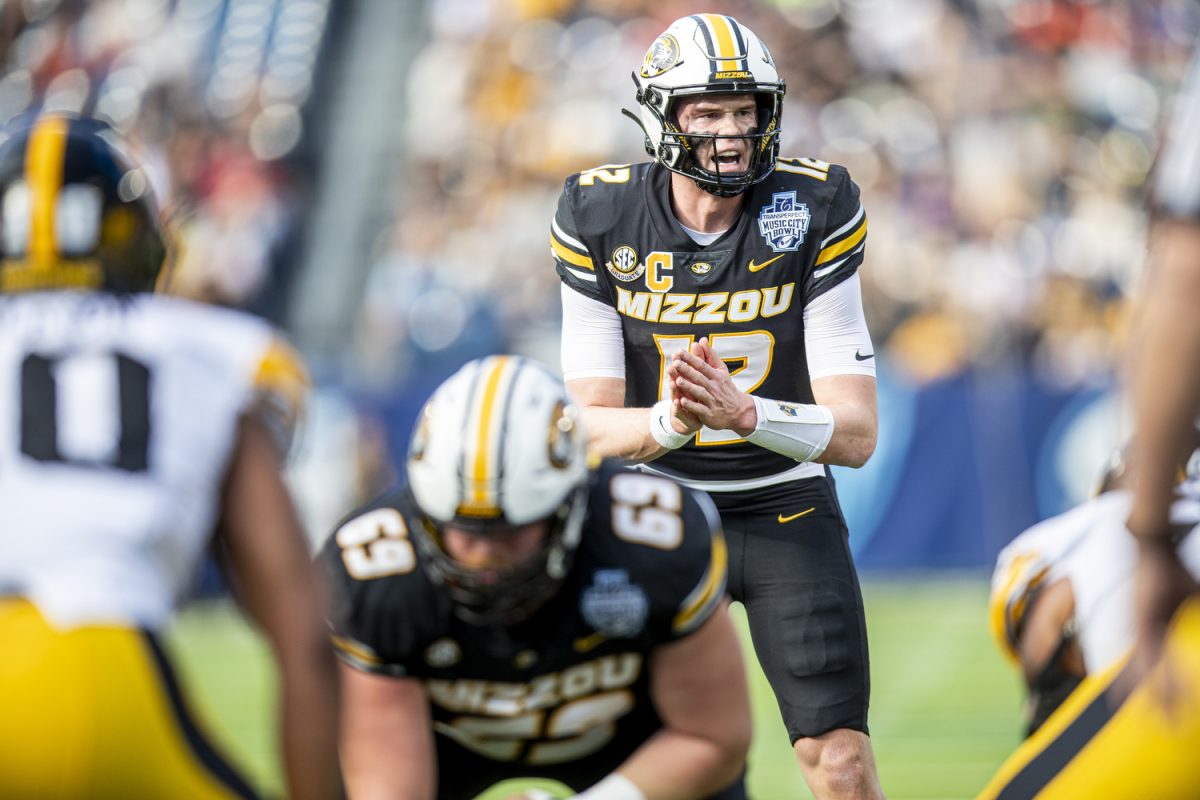 Missouri quarterback Brady Cook prepares to snap the ball during the TransPerfect Music City Bowl between Iowa and Missouri at Nissan Stadium in Nashville, Tenn., on Monday, Dec. 30, 2024. Following the first half, Iowa leads Missouri 21-14.