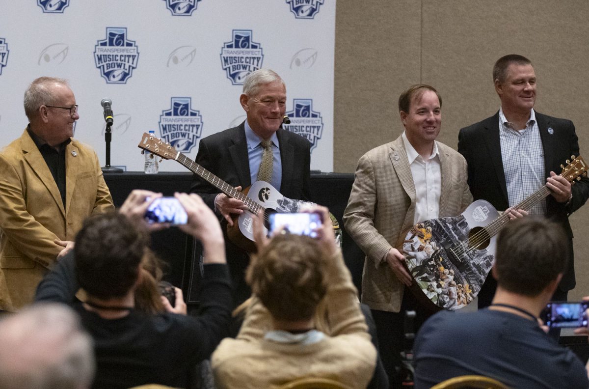 Head coaches Kirk Ferentz and Eliah Drinkwitz pose for a picture after accepting customized guitars during a press conference in the Gaylord Opryland Resort in Nashville, Tenn., on Sunday, Dec. 29, 2024. Head coaches Kirk Ferentz and Eliah Drinkwitz, as well as both team's defensive and offensive coordinators, spoke about the game and answered questions from the media. The Iowa Hawkeyes and Missouri Tigers will face off in the 2024 TransPerfect Music City Bowl on Monday, Dec. 30, at Nissan Stadium.