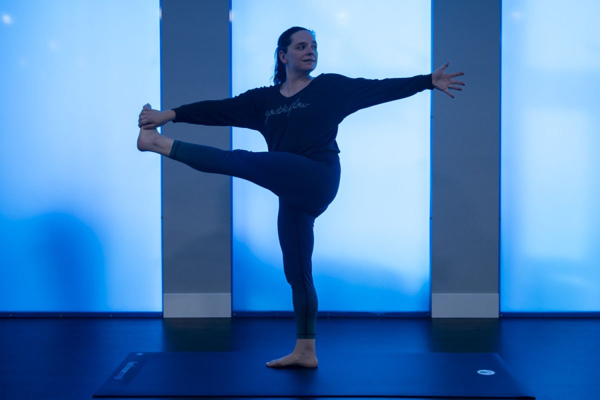 Clara Viner, owner of Hot House Yoga, demonstrates a pose at the North Liberty, Iowa location on Monday, Dec. 9, 2024. Hot House Yoga has three locations, including in Iowa City and Coralville.