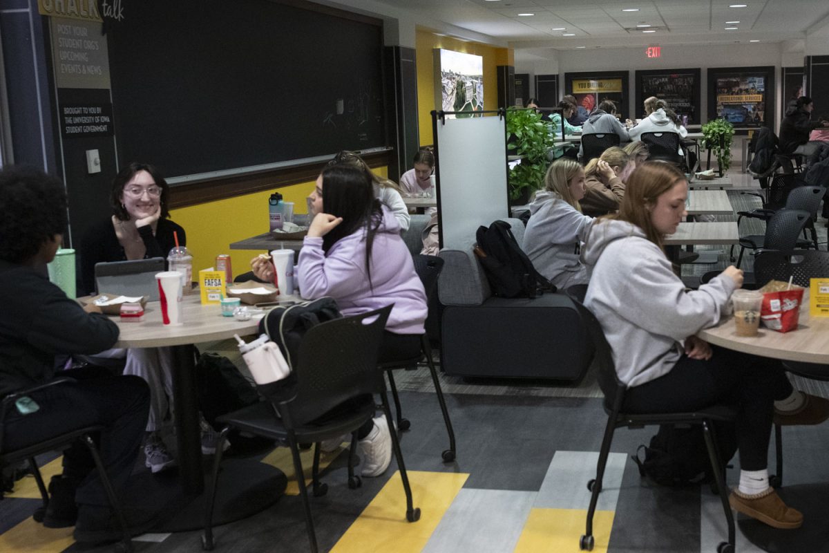 Students commerce at the Iowa Memorial Union on Dec. 9, 2024. The IMU holds daily events during finals week for students including free food, drinks, massages, and games.