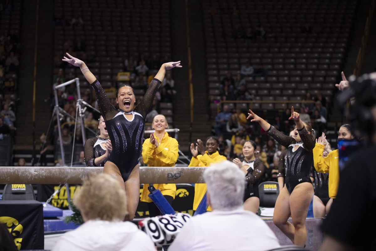 Former Olympian Cassie Lee celebrates her dismount during the Iowa Women’s Gymnastics team’s Black and Gold Intrasquad exhibition at Carver-Hawkeye Arena on Dec. 7, 2024. Lee competed in the 2024 Paris Olympics for team Canada.