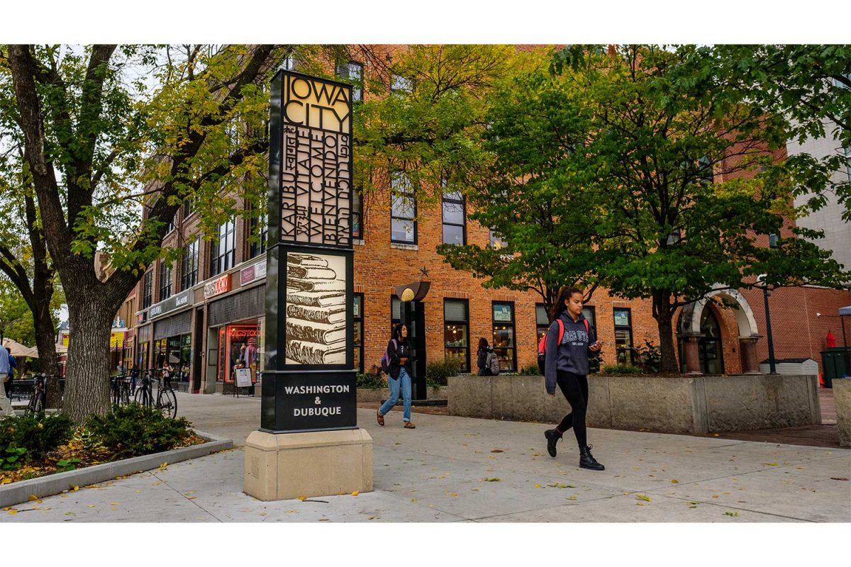 A literature themed sign welcoming visitors to Iowa City is seen on the corner of Washington and Dubuque Streets on Thursday, Oct. 12, 2017. 