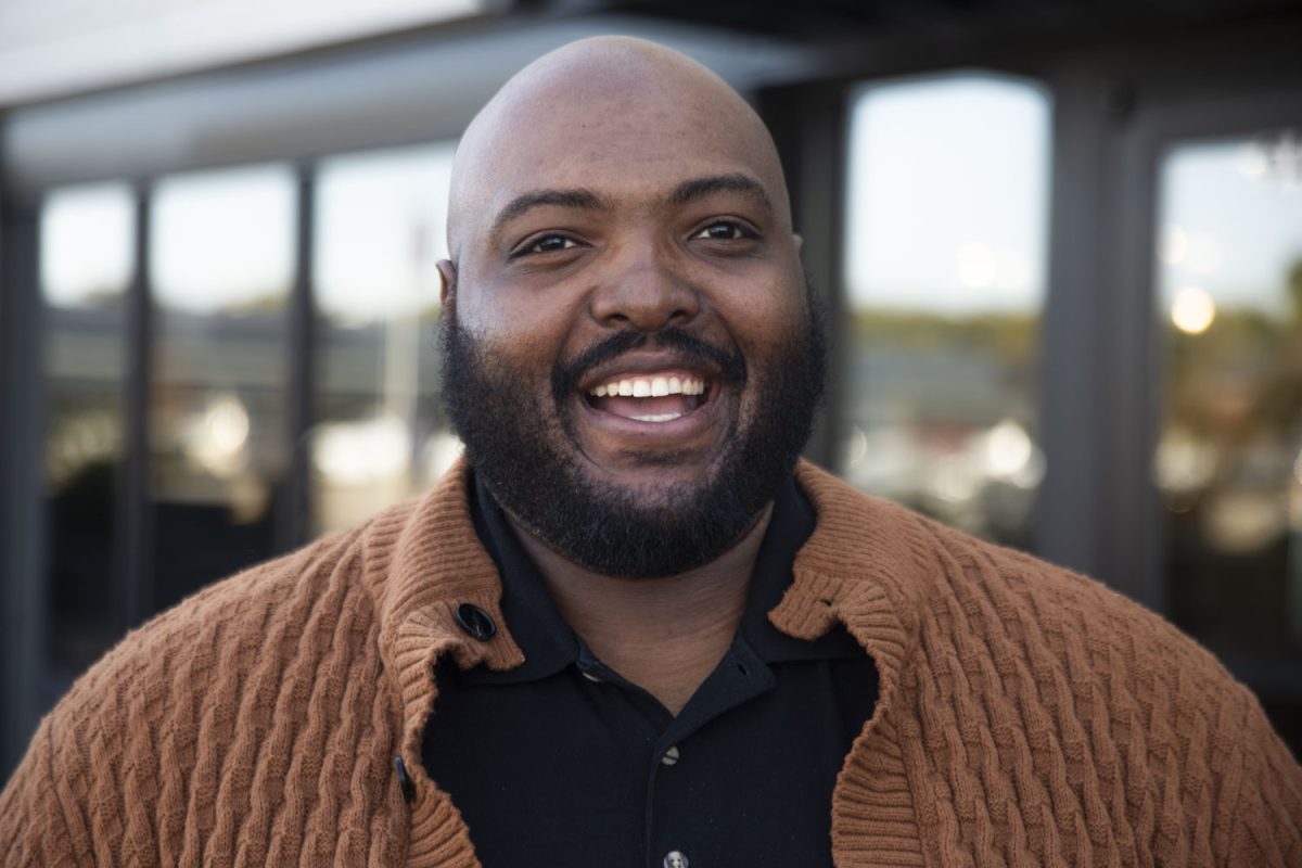 South of 6 Executive Director Maurice Davis poses for a portrait outside of the South District Market building in Iowa City on Monday, Oct. 21, 2024.