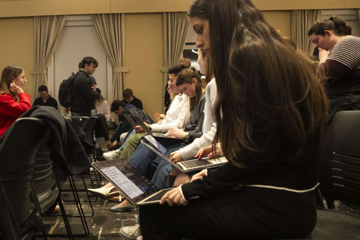 Senators study practice bills during a meeting of the Undergraduate Student Government in the Iowa Memorial Union on Tuesday, Jan 28, 2025. USG swore in six new members and welcomed the campus Ombudsperson to speak about his role.