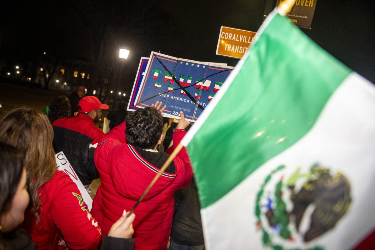 Demonstrators march during an immigration protest in downtown Iowa City on Friday, Feb. 3, 2025. Dozens of demonstrators danced, sang, chanted, and marched throughout the early evening. A handful of counter-protesters were in attendance.