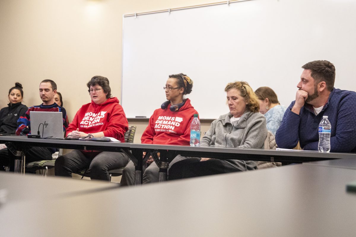 Veteran and activist Temple Hiatt (second from left) speaks during a Moms Demand Action meeting at the Public Library in Iowa City on Monday, Feb. 10, 2025. Both city council special election candidates Ross Nusser and Oliver Weilein had about 10 minutes to read statements and answer questions concerning their policies on gun safety. 