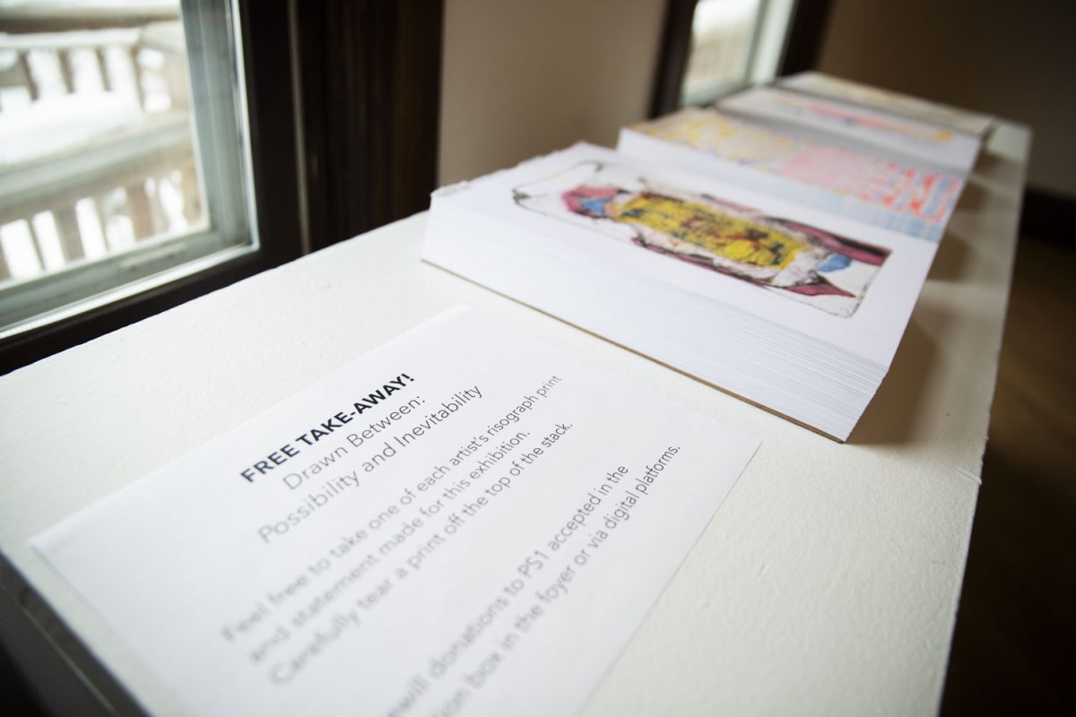 Free copies of risograph prints by each artist sit on a table at the Drawn Between art exhibit inside Public Space One on North Gilbert Street on Saturday, Feb. 15, 2025. Drawn Between: Possibility &amp; Inevitability features drawings by artists Jen P. Harris, R. Kauff, Kathranne Knight, and Ajdin Kulicˊ. The exhibit explores drawn pieces of artwork and the connection between possibility and inevitability that comes with the act of drawing.