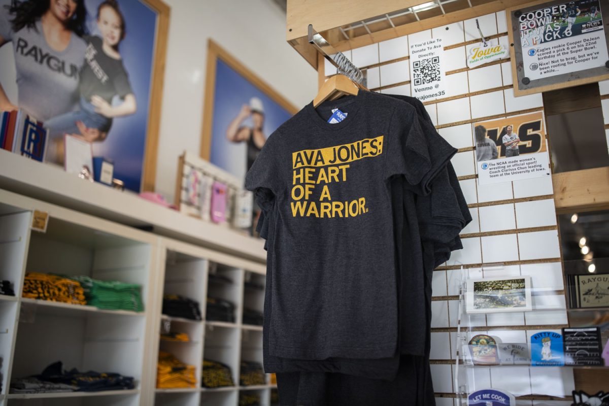 An Ava Jones t-shirt is seen on display at Raygun in downtown Iowa City on Monday, Feb. 17, 2025. A portion of the officially licensed clothing’s proceeds go towards Ava Jones, but a QR code link to directly donate to Ava Jones is displayed in the store next to the shirts.