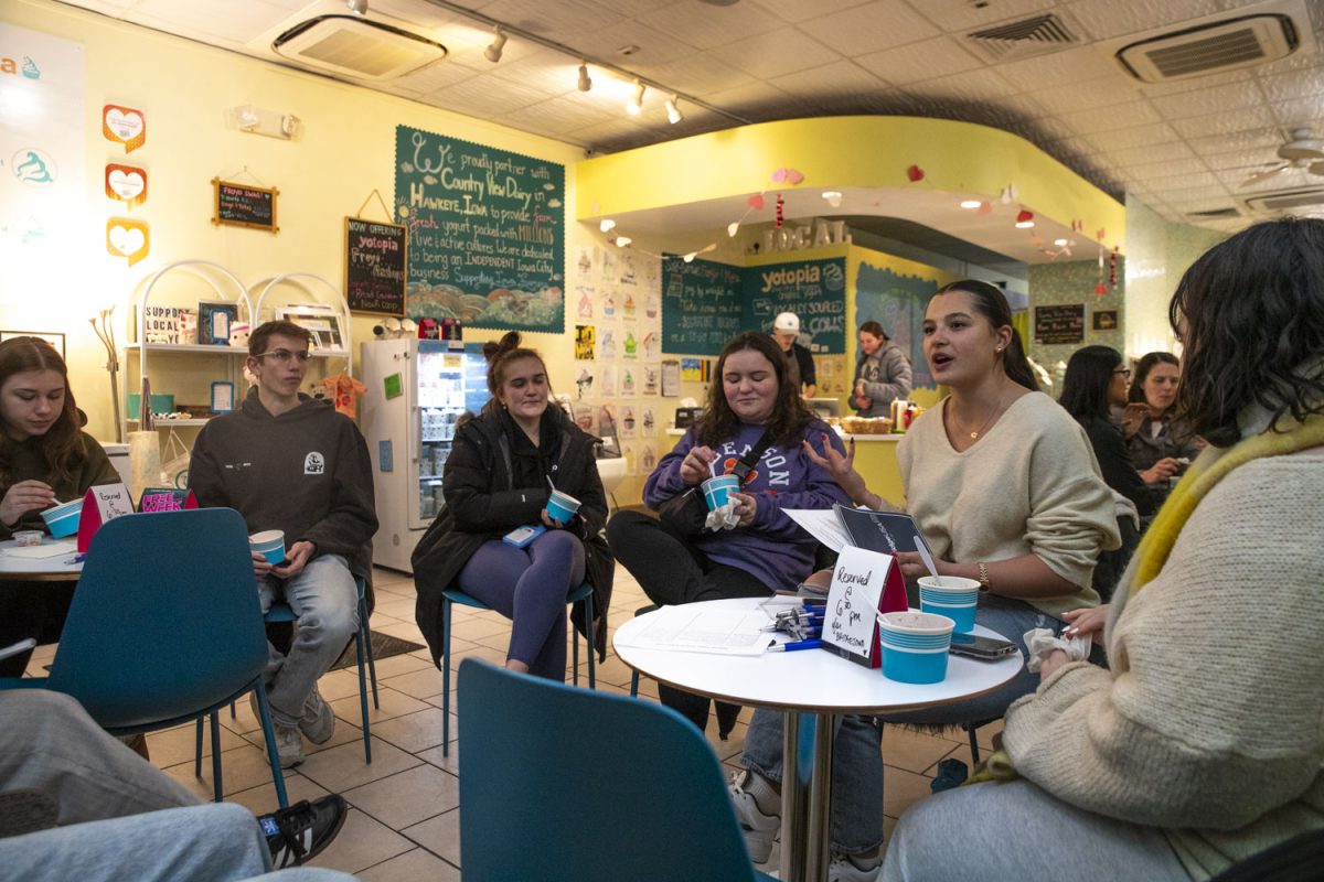 Cielo Herrera leads a discussion on President Donald Trump’s executive orders during a meeting of the Iowa chapter of Bridge USA at Yotopia Frozen Yogurt in Iowa City on Wednesday, Feb. 19, 2025. Bridge Iowa was started by Herrera to encourage people of different political ideologies to find common ground.