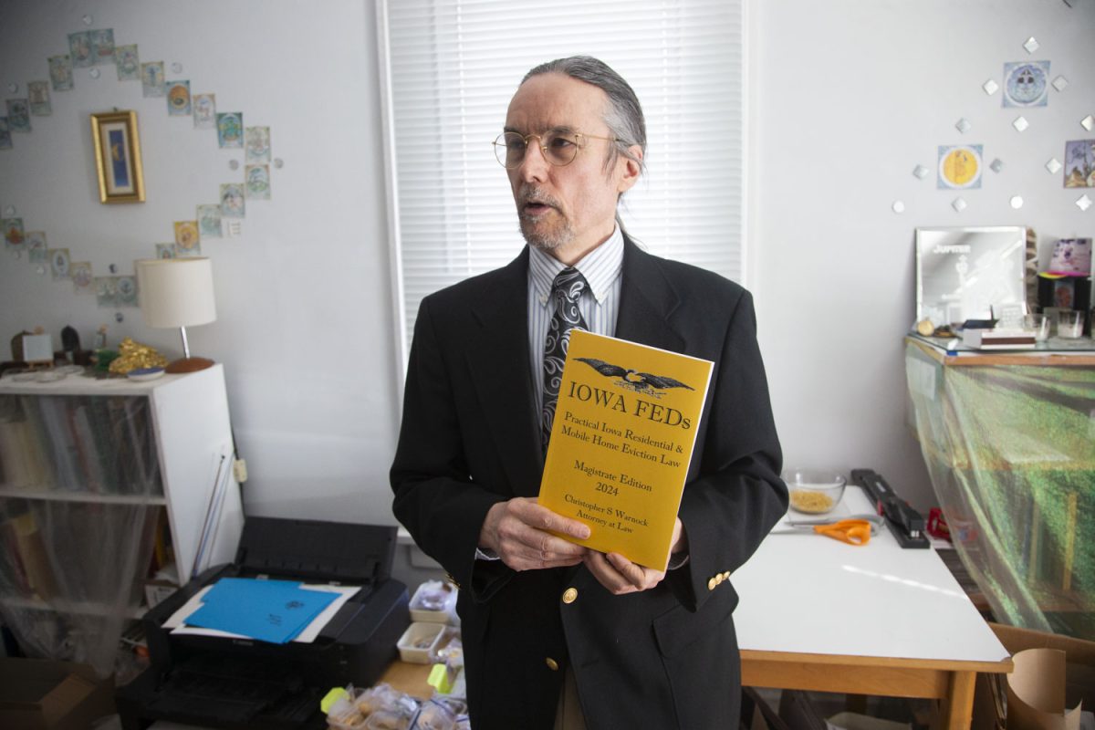 Christopher Warnock poses for a portrait in his home in Iowa City on Feb. 21. Warnock is a local attorney at law with five cases that have reached the Iowa Supreme Court.