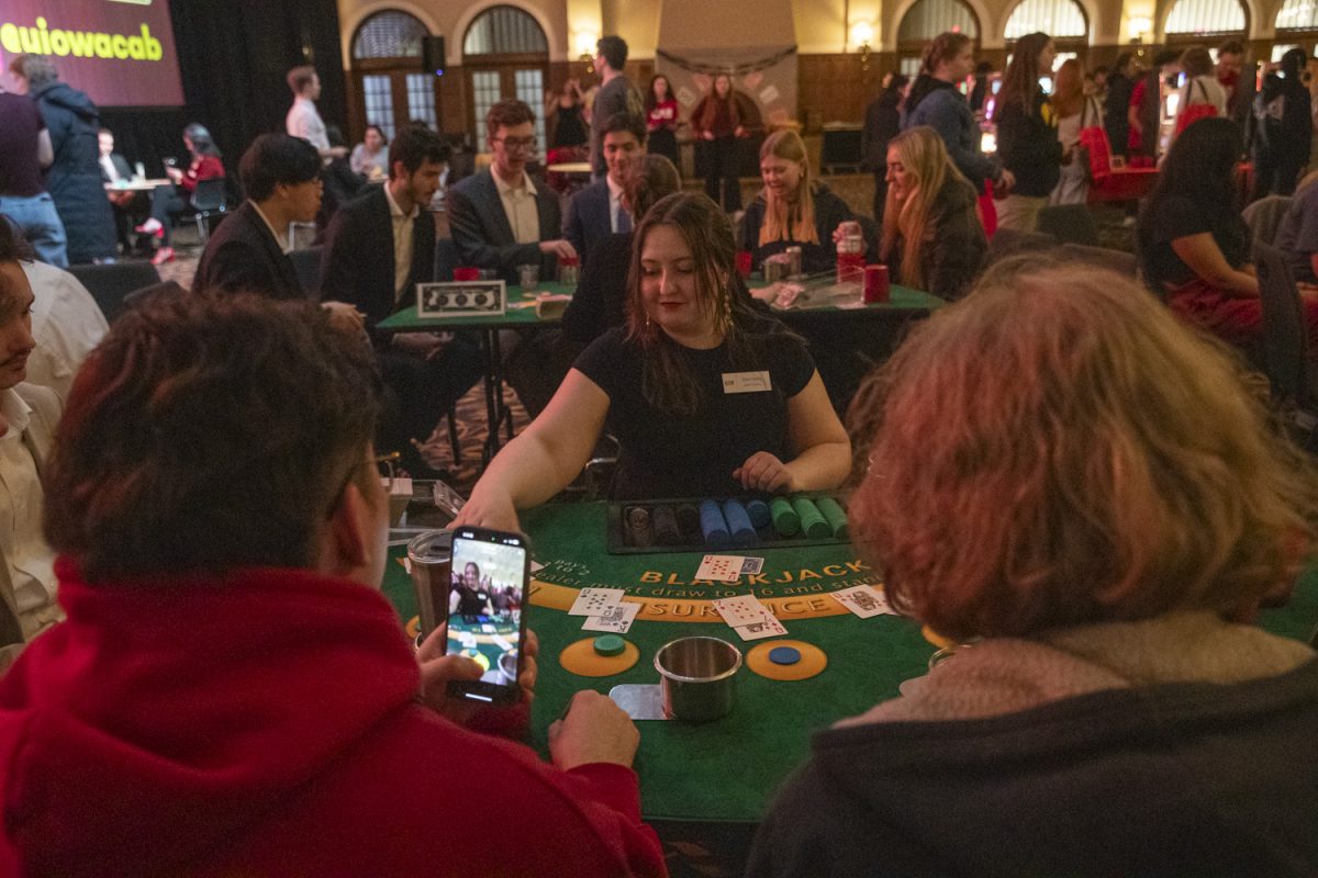 Attendees play at a card table during Casino Night at the Iowa Memorial Union on Saturday, Feb. 22, 2025. The event was hosted by the Campus Activities Board and had a turnout of over two hundred students.