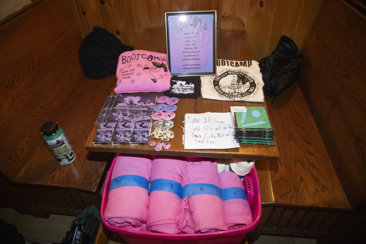Merchandise is sold for the band Bootcamp during a Get Out The Vote show for Oliver Weilein’s City Council campaign at Trumpet Blossom on Thursday, Feb. 27, 2025. Multiple artists performed screams, poetry, and folk songs, including Weilein’s band Bootcamp.