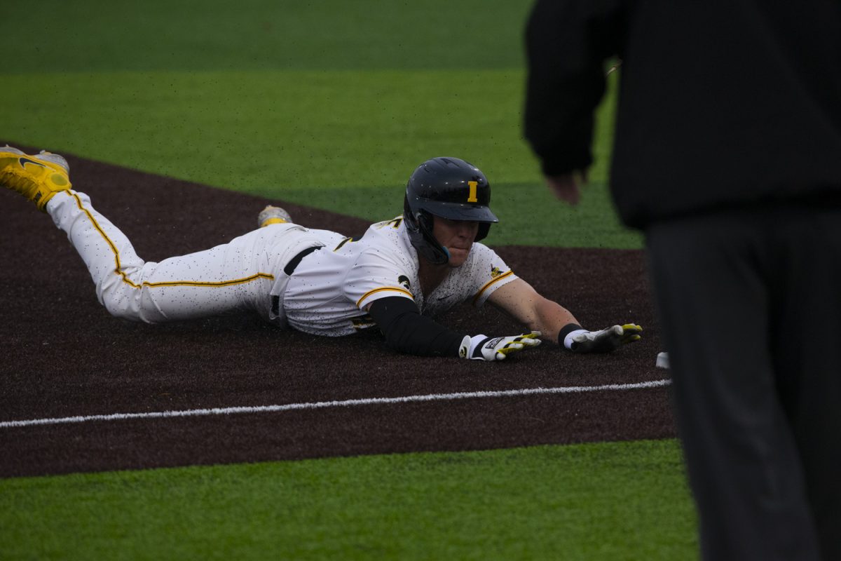 Iowa catcher Max Burt slides into third base during a men's baseball game between Iowa and Loras College at Duane Banks Baseball Stadium in Iowa City on Mar. 3, 2025. The Hawkeyes defeated the Duhawks, 11-3.
