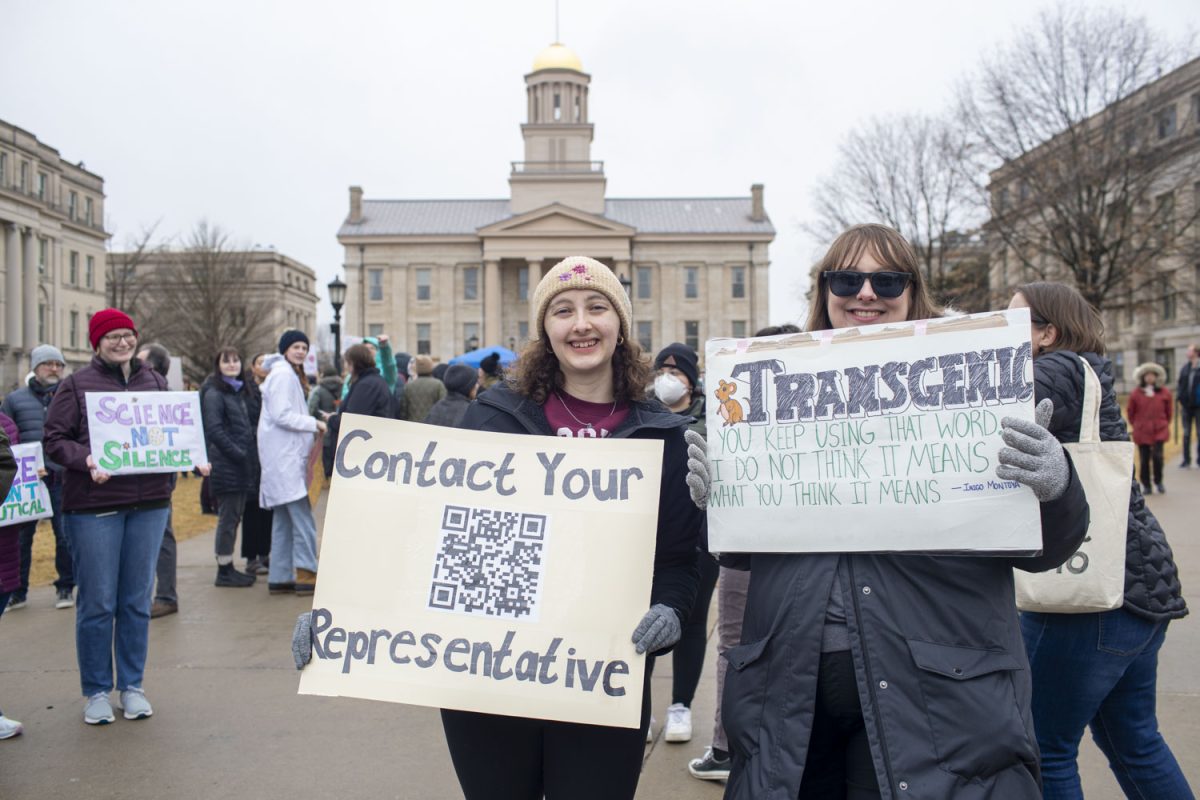 Protestors hold up homemade signs during a Stand Up For Science rally on the Pentacrest on Friday, March 7, 2025. The rally was one of many being held nationally to protest against the Trump administration’s “censorship and political interference” in scientific research. Speakers at the event encouraged attendees to chant, cheer, and call their representatives. Live music was performed by the band Second Half.