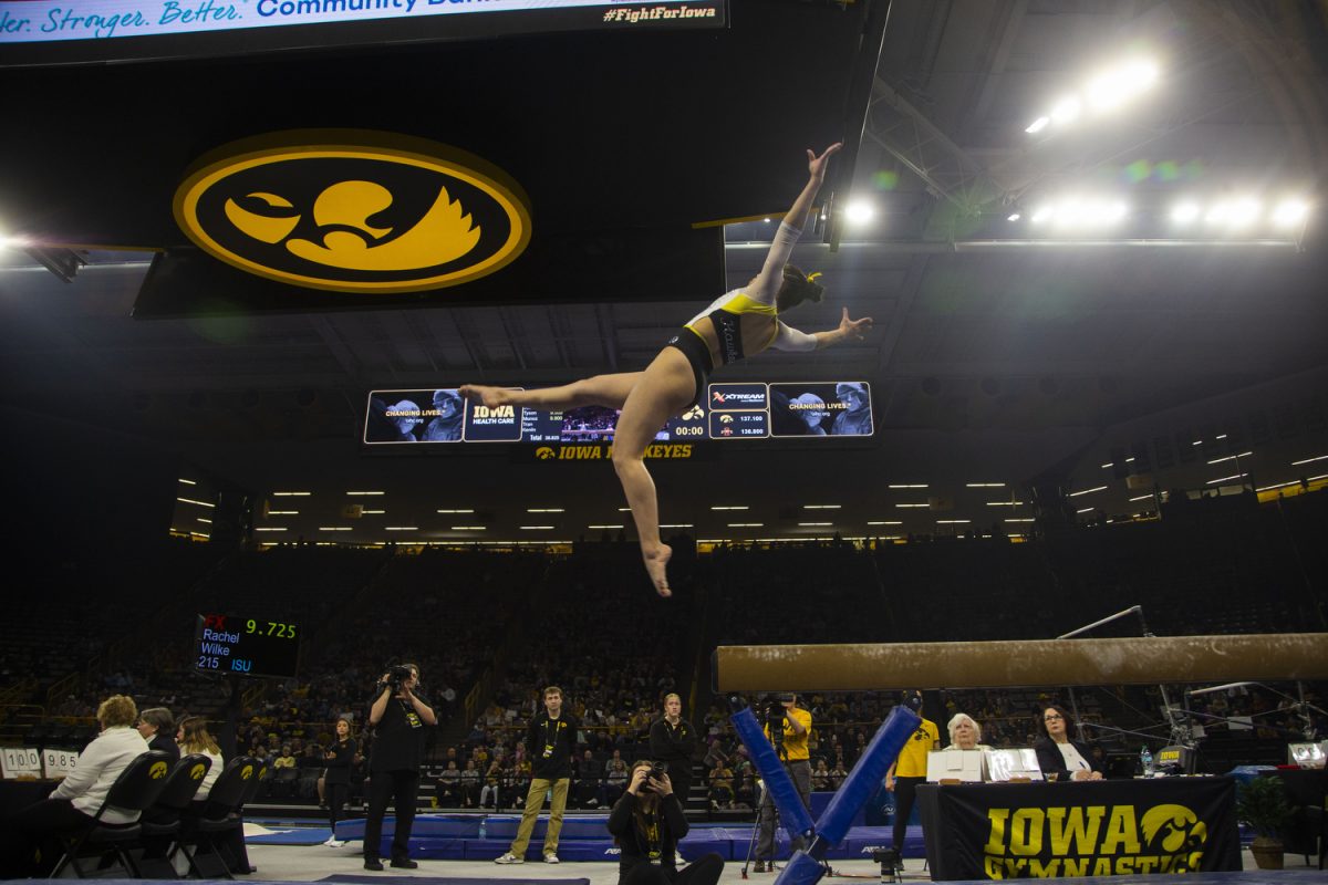 Gymnast Aurelie Tran completes her dismount during the Iowa Gymnastics senior night at Carver-Hawkeye Arena on March 7, 2025. Tran scored a 9.850 on the balance beam.